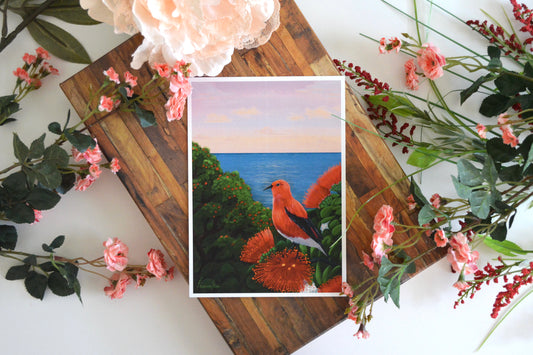 Art print with illustration of a Hawaiian black and red apapane (honey creeper) perched on ohia lehua with ocean horizon in background.