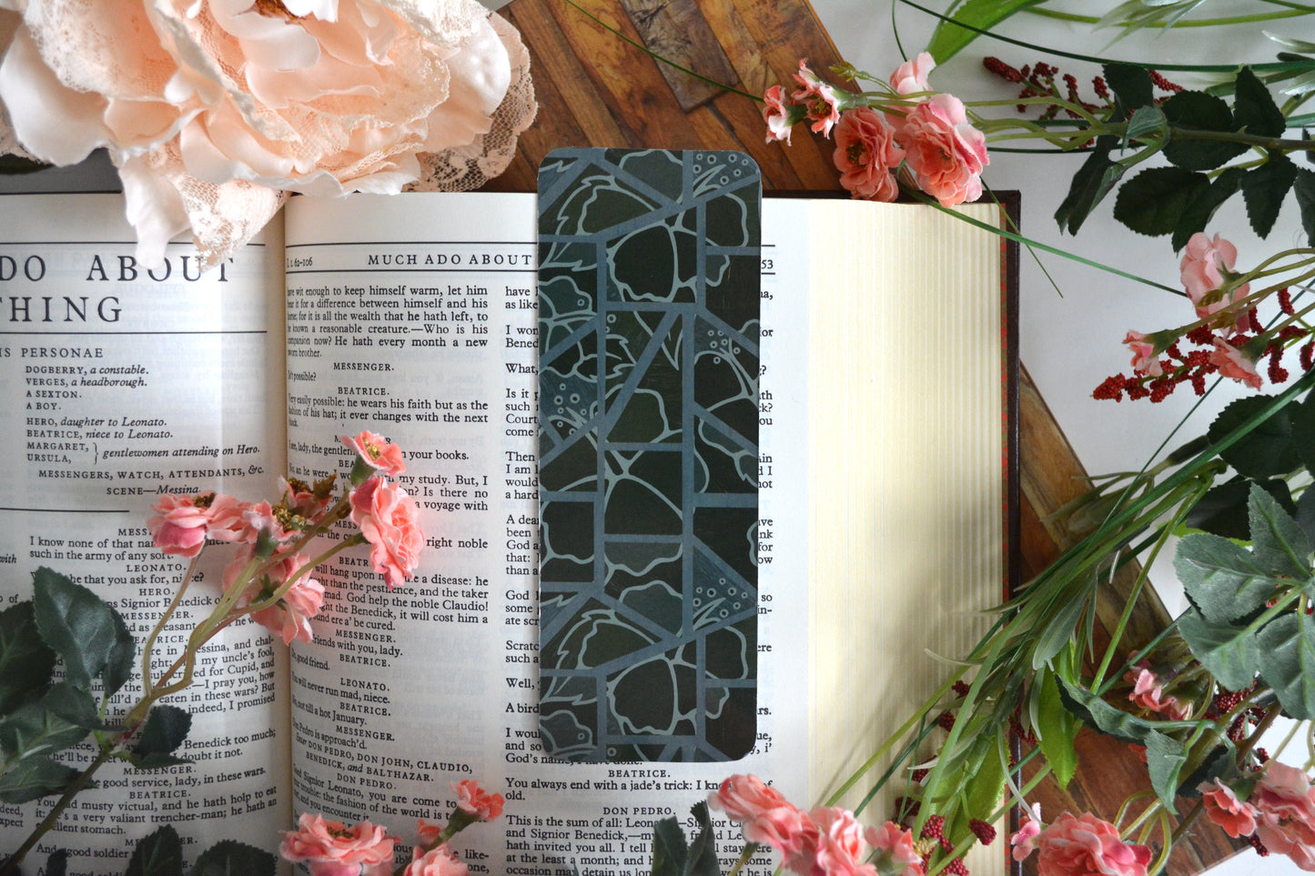 Bookmark with illustrations of mosaic tiles of hibiscus in varying shades of dark green.