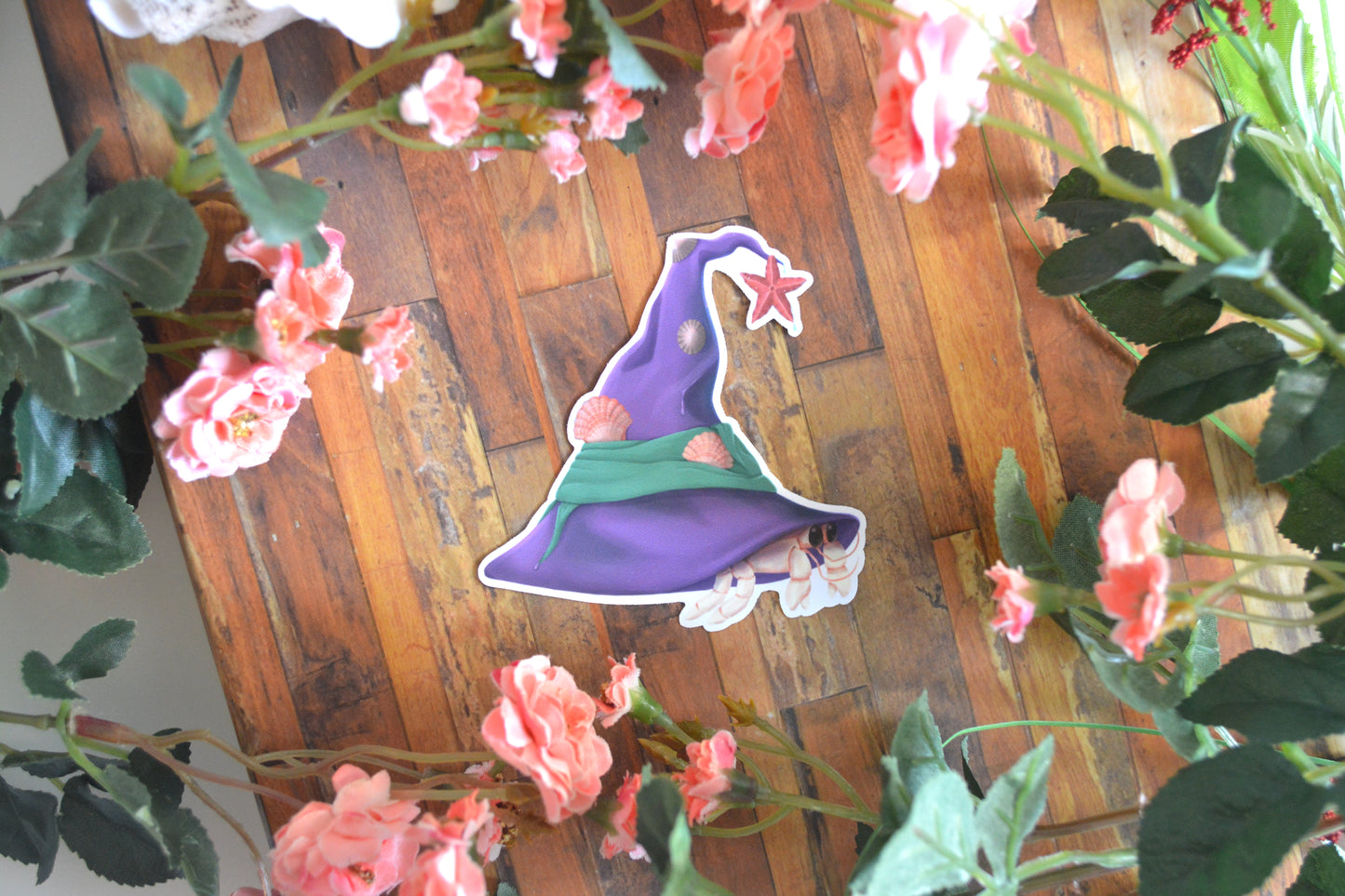 Halloween sticker of a hermit crab wearing a witch's hat and using it as its shelter