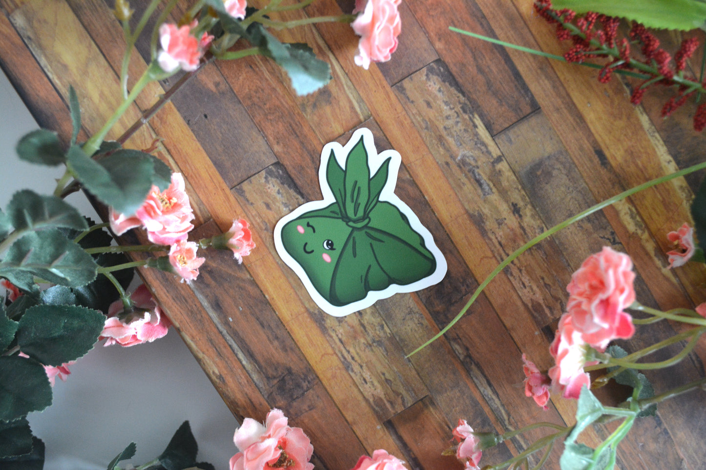 Individual sticker of a Hawaiian laulau with a cute kawaii facial expression.
