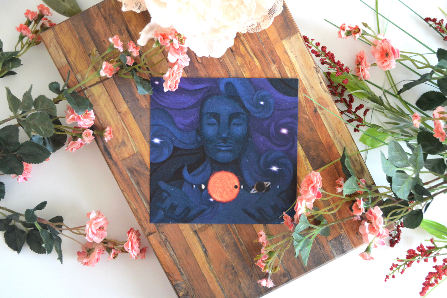 Art print with illustration of a feminine character as the universe holding the solar system between her hands.