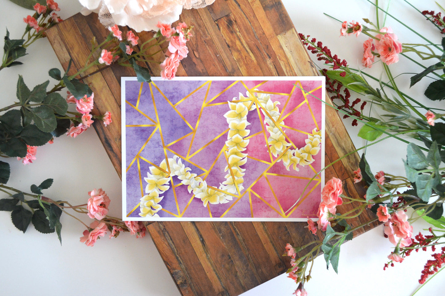 Art print with illustration of a Hawaiian yellow plumeria lei intertwined throughout gold lines on a triangular mosaic in shades of purple and pink.