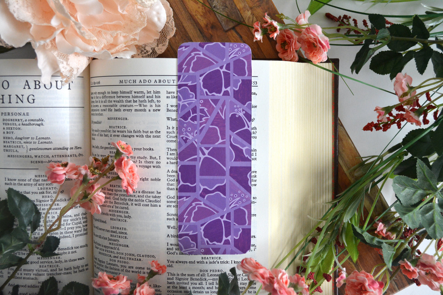 Bookmark with illustrations of mosaic tiles of hibiscus in varying shades of purple.