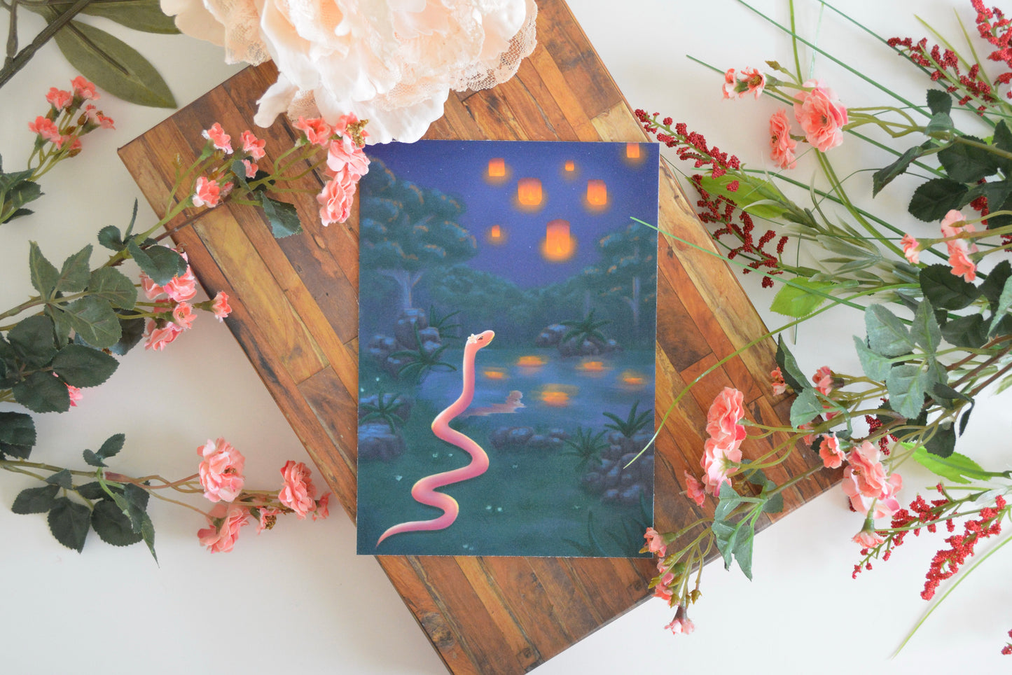 2025 Year of the Snake art print with illustration of pink snake and glowing paper lanterns inspired by the Chinese Zodiac and New Year.