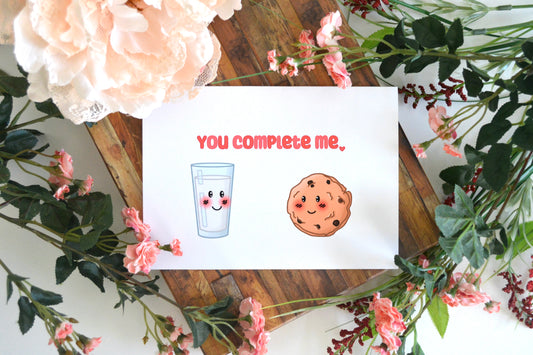 Greeting card with "You Complete Me" text and milk and cookie images on front.