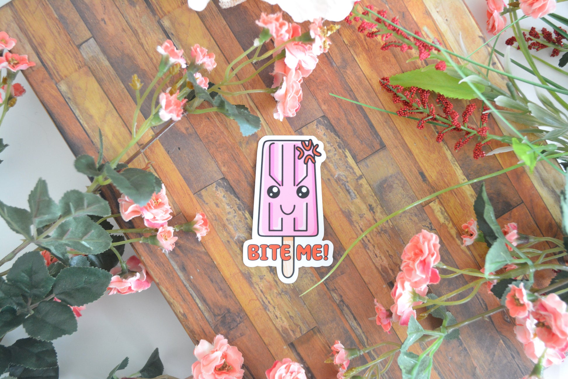 Individual sticker of a cute and sassy popsicle with the text "Bite Me!"