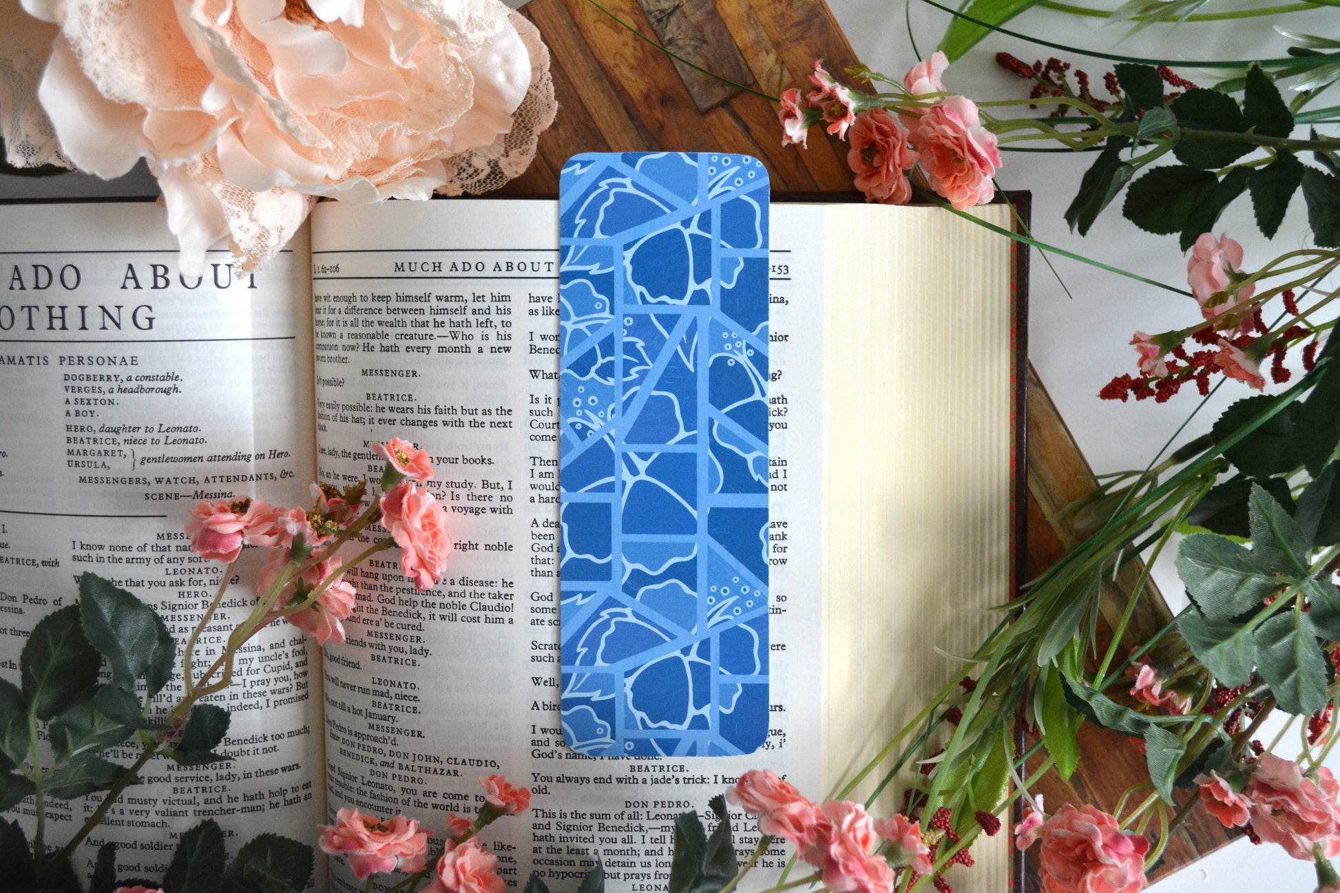 Bookmark with illustrations of mosaic tiles of hibiscus in varying shades of light blue.