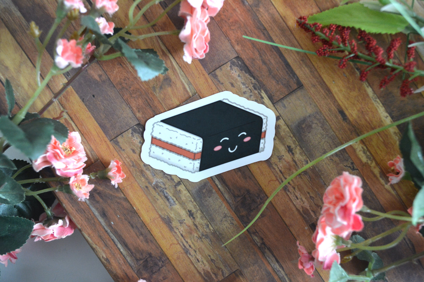 Individual sticker of a spam musubi illustration with a cute kawaii facial expression.