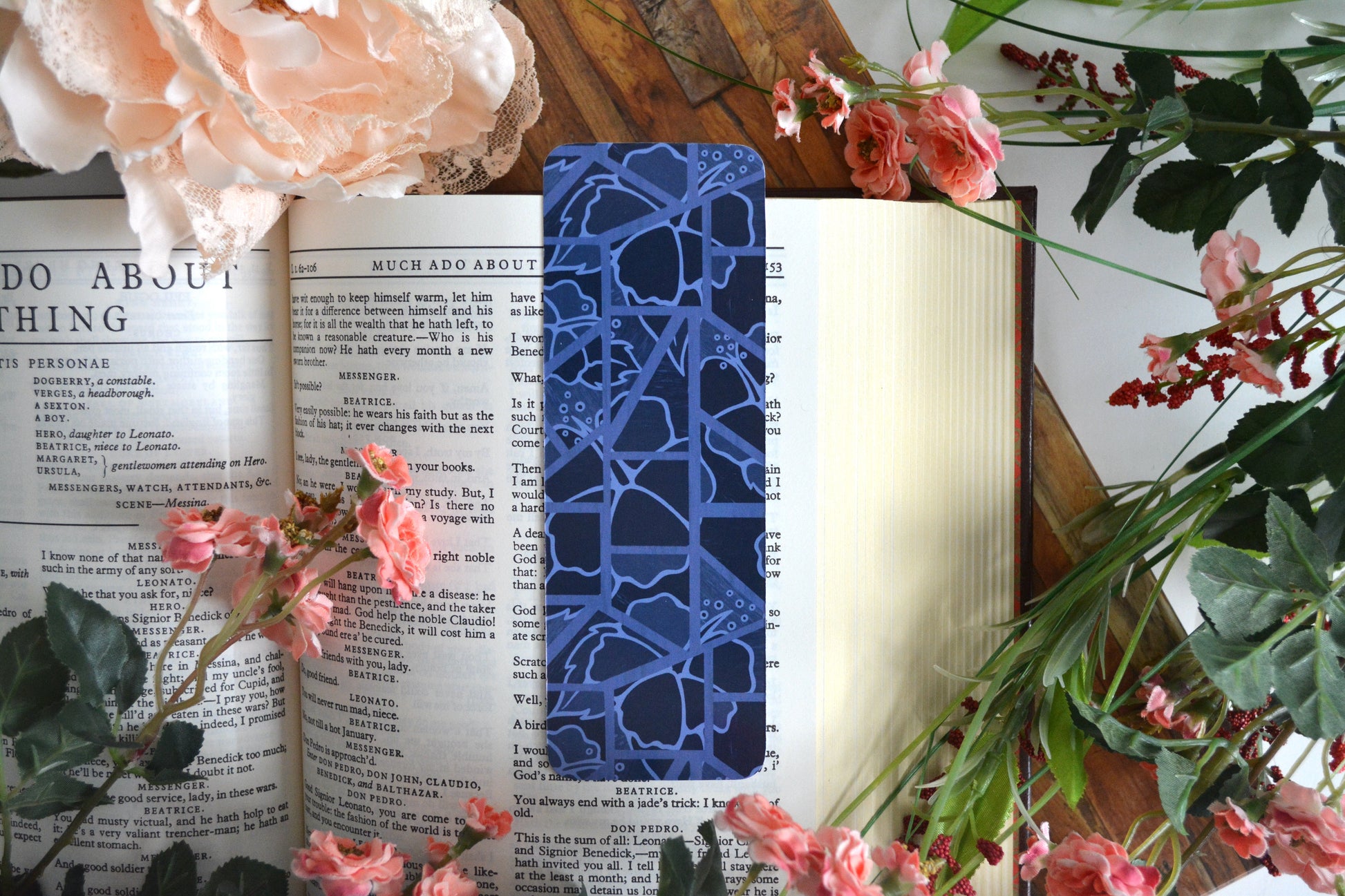 Bookmark with illustrations of mosaic tiles of hibiscus in varying shades of blue.
