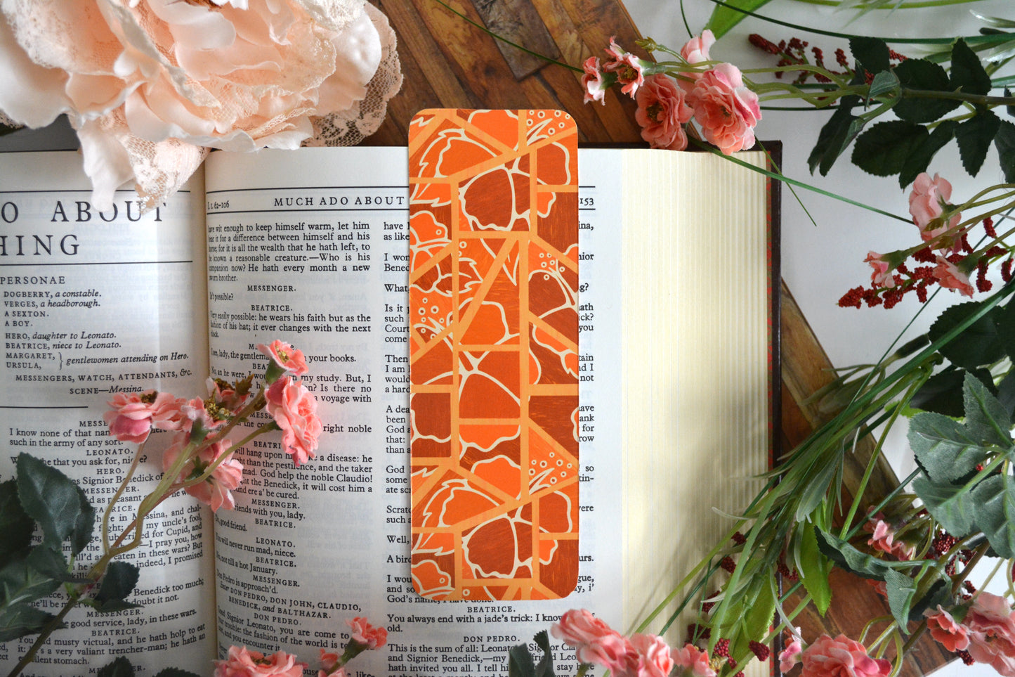 Bookmark with illustrations of mosaic tiles of hibiscus in varying shades of orange.