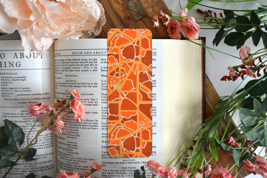 Bookmark with illustrations of mosaic tiles of hibiscus in varying shades of orange.