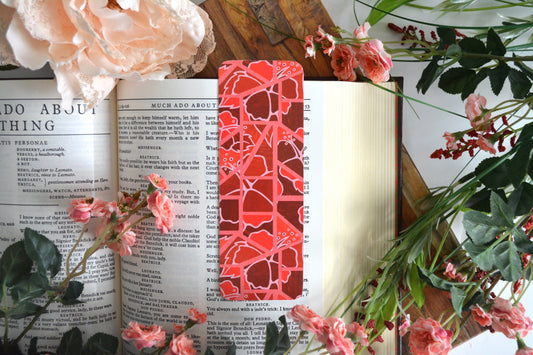 Bookmark with illustrations of mosaic tiles of hibiscus in varying shades of red.