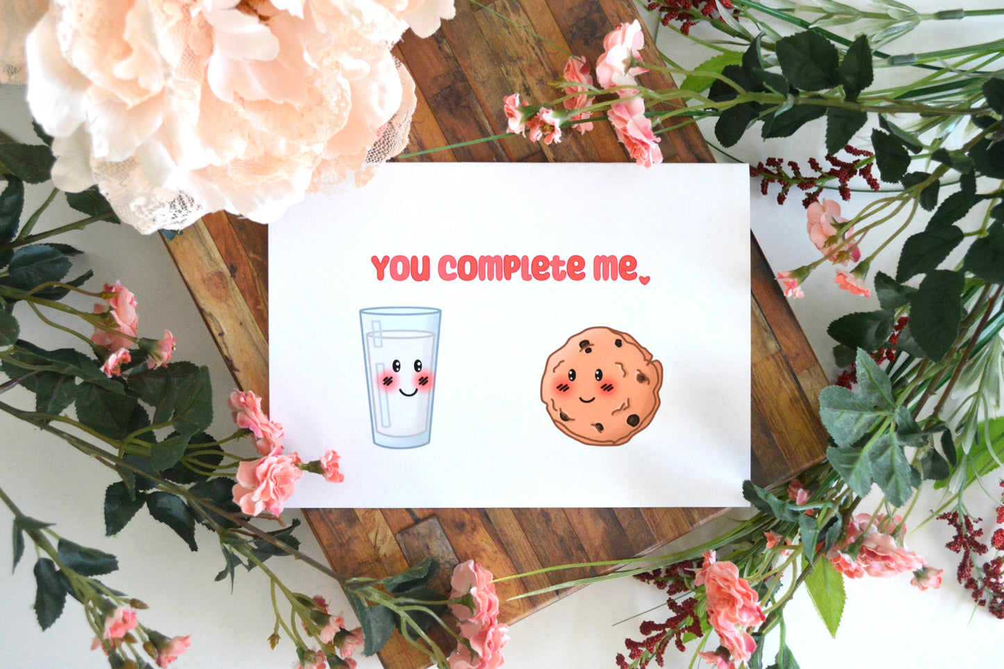 Greeting card with "You Complete Me" text and milk and cookie images on front.